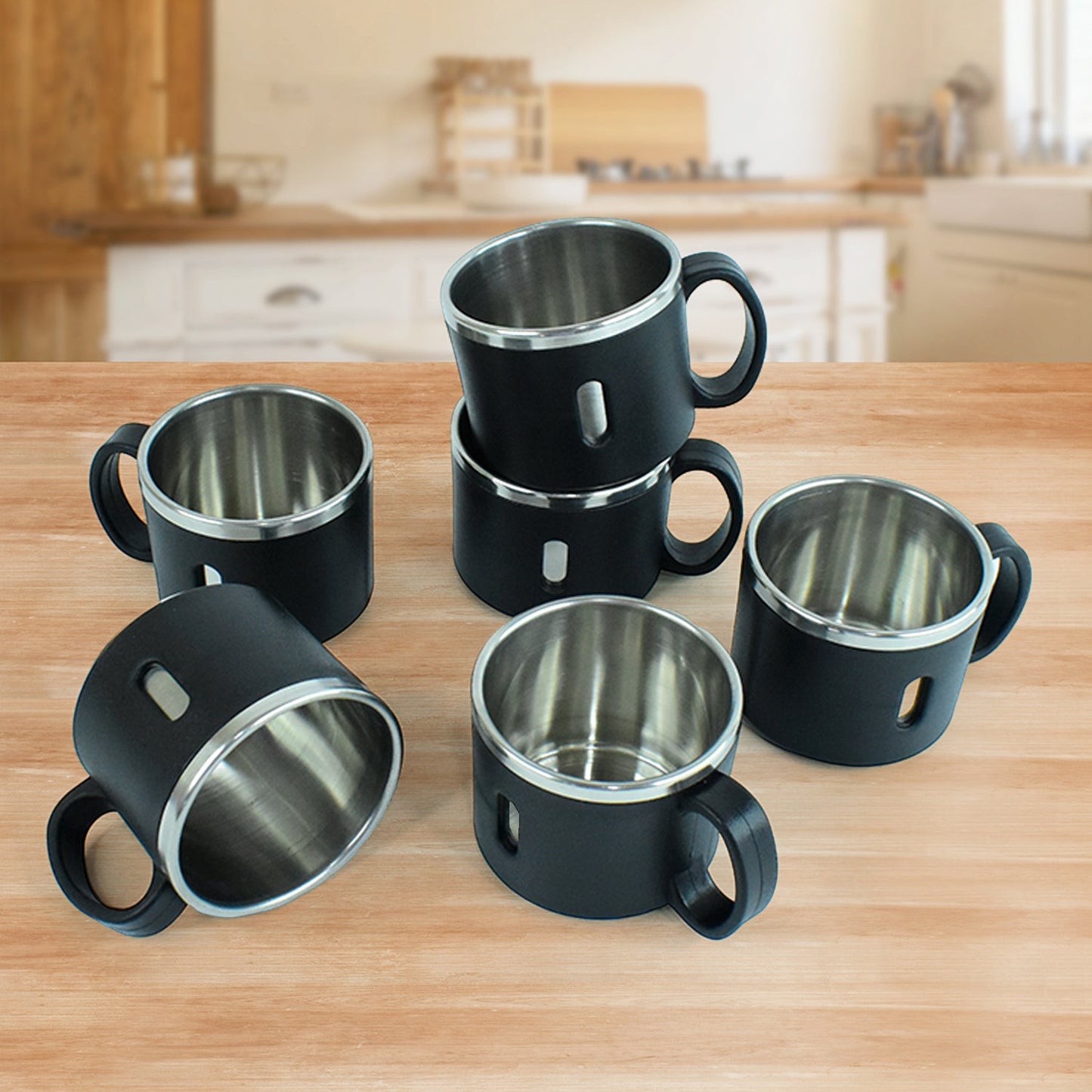 Ergonomic stainless steel desk mug on an office desk