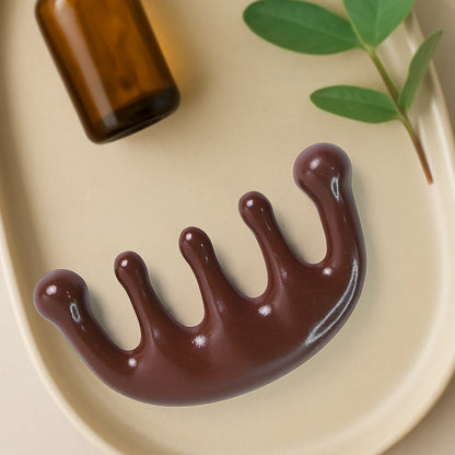 Close-up view of durable scalp relaxing manual head massager comb