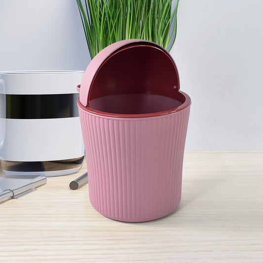 Close-up of mini tabletop dustbin with easy-to-use swing lid