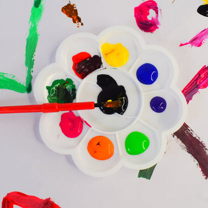 Kid using bright watercolour paints from the artistic water colour kit set