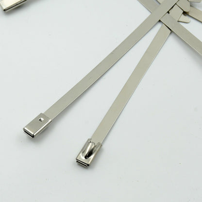 Durable stainless steel cable tie securing electrical wiring in an industrial setting.