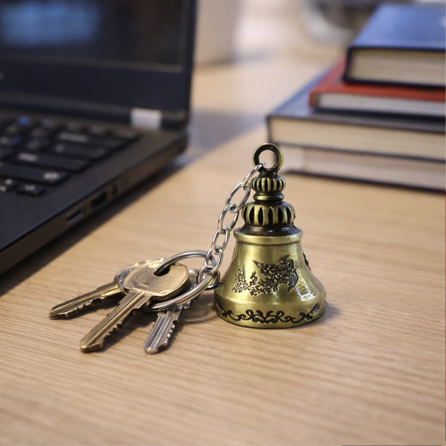 Detailed view of the metal temple bell keychain showcasing its intricate spiritual design.
