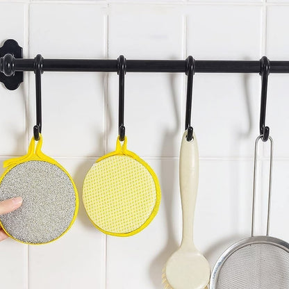 Close-up image of double-sided kitchen cleaning dishwashing sponge brush