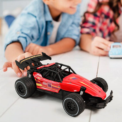 Red RC race car showing action shot on rough terrain for kids