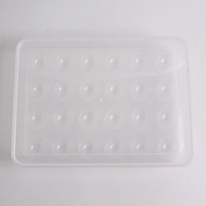 Clear plastic egg container next to traditional egg carton for size comparison