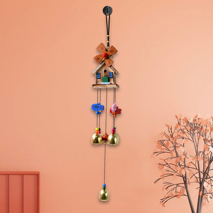 Vivid dragonfly wind chime hanging outdoors catching sunlight