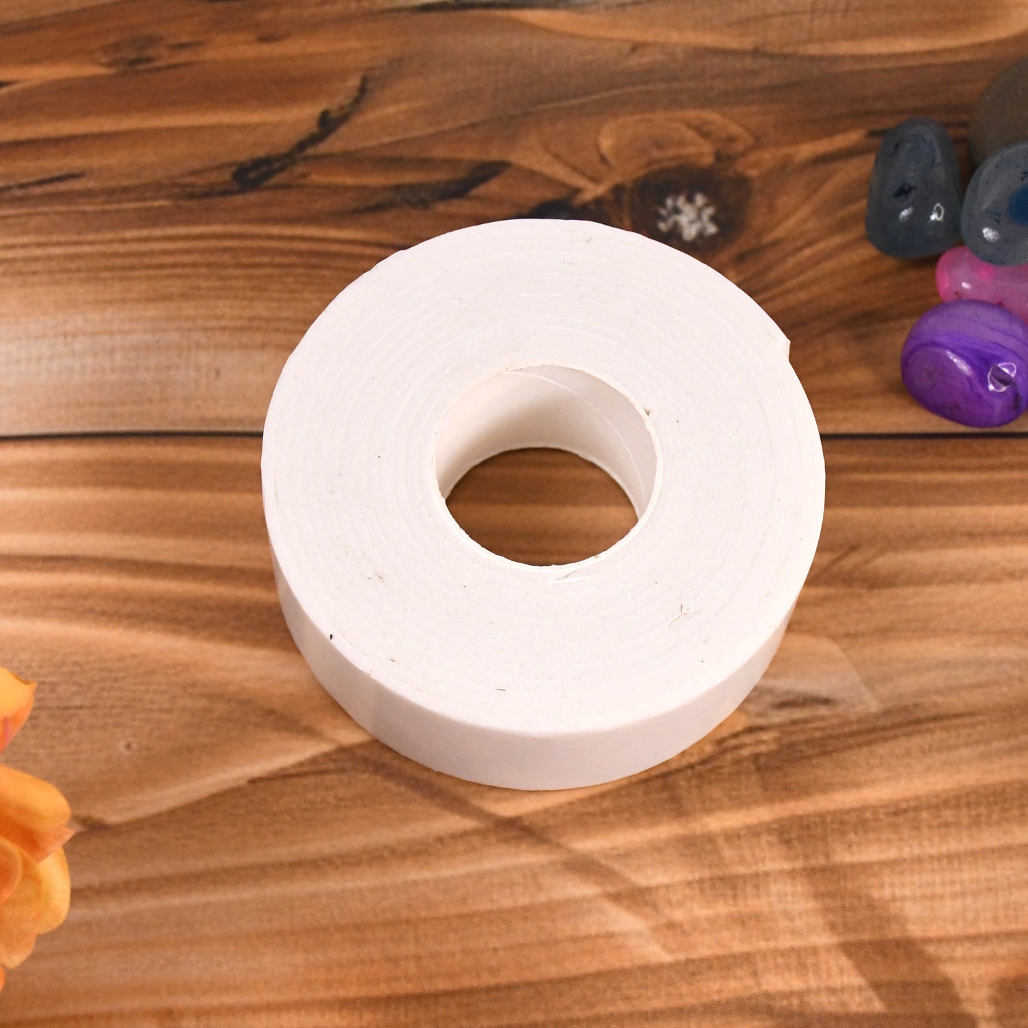 Close-up of double sided foam mounting tape applied to a smooth surface.