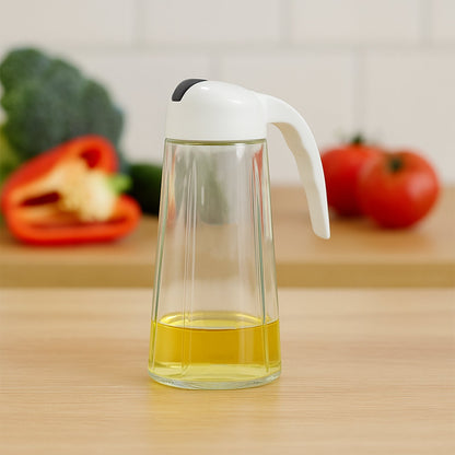Glass oil bottle dispenser showing measuring marks and leak-proof spout