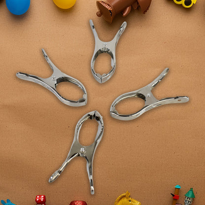 Durable stainless steel clothespins showcasing strong grip on towels.