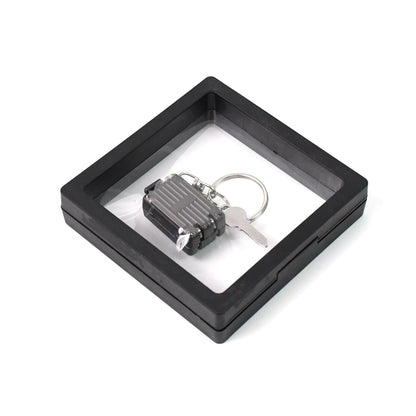 Nail clipper keychain attached to travel essentials with suitcase shape