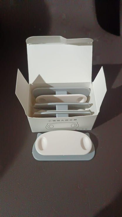 Pig plug shaped cable organizer clips holding multiple cables