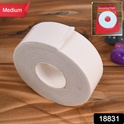 Double sided foam mounting tape securely holding a picture frame on a wall.