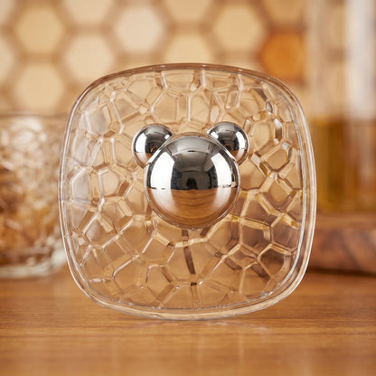 Set of three clear plastic adhesive wall hooks displayed on a flat surface.