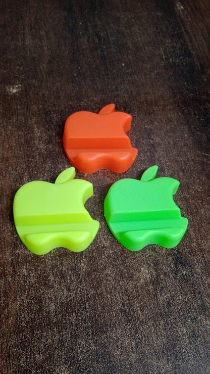 Compact apple-style mobile phone stand in assorted color variants