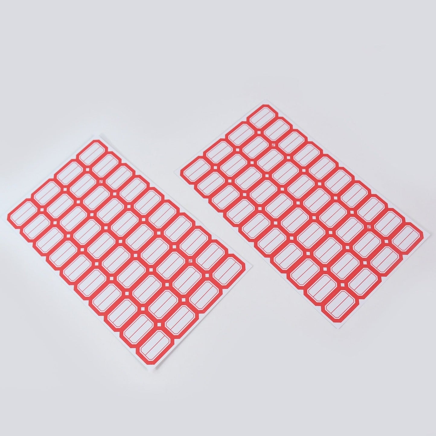 Hand writing on red border label sticker demonstrating its smooth writable surface.