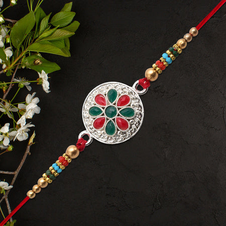 Silver Plated Floral Rakhi With Red  Green Stones